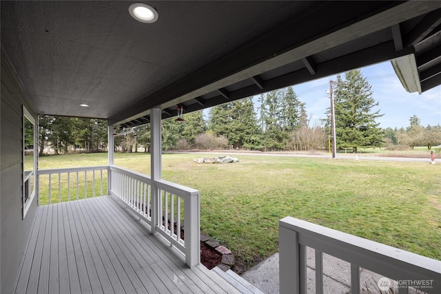 wooden terrace with a lawn