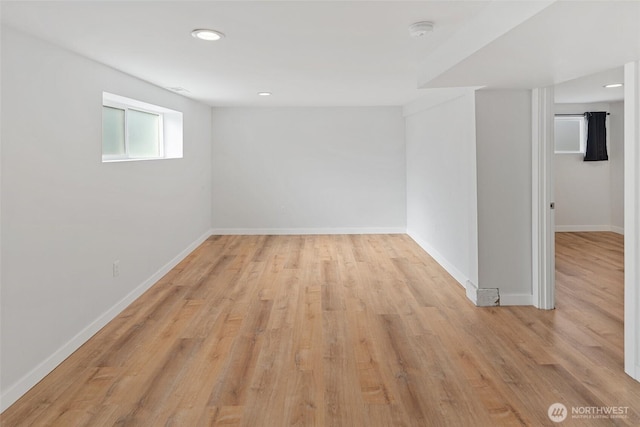 unfurnished room with recessed lighting, light wood finished floors, and baseboards