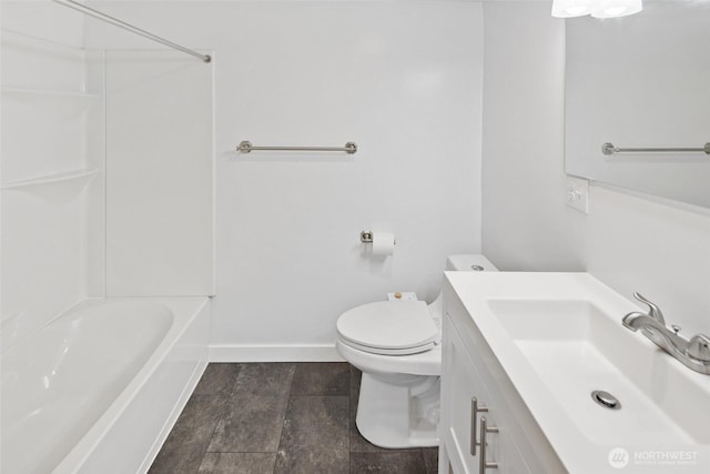 bathroom with toilet, baseboards, shower / washtub combination, and vanity