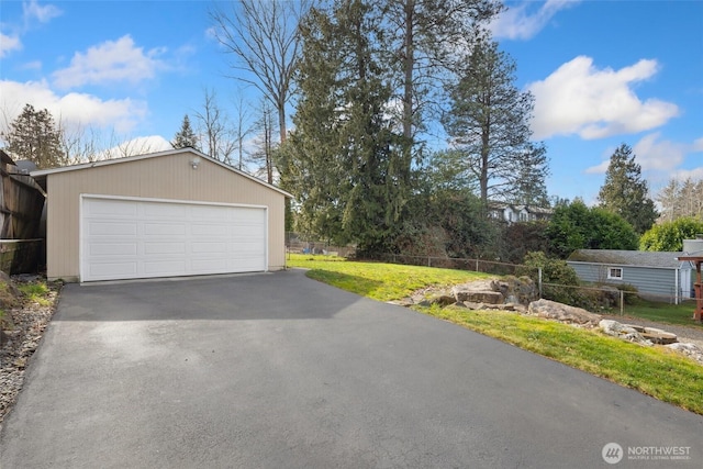 detached garage featuring fence