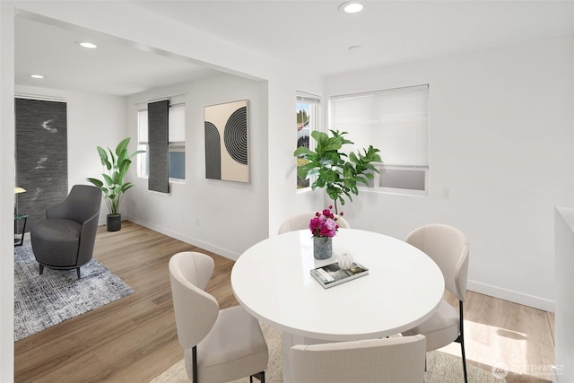 dining area featuring light wood-style flooring, baseboards, and recessed lighting