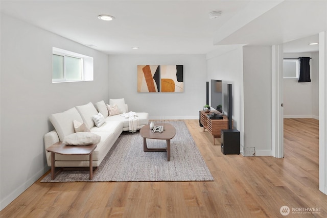 living area with baseboards, wood finished floors, and recessed lighting