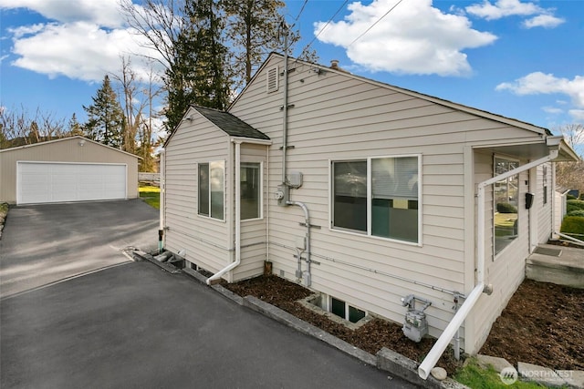 view of side of property featuring a detached garage and an outdoor structure