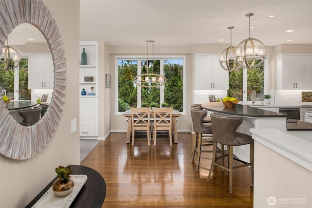 9330 SE Shoreland Dr, Bellevue, WA 98004 - dining space featuring baseboards, dark wood-style flooring, a notable chandelier, and recessed lighting