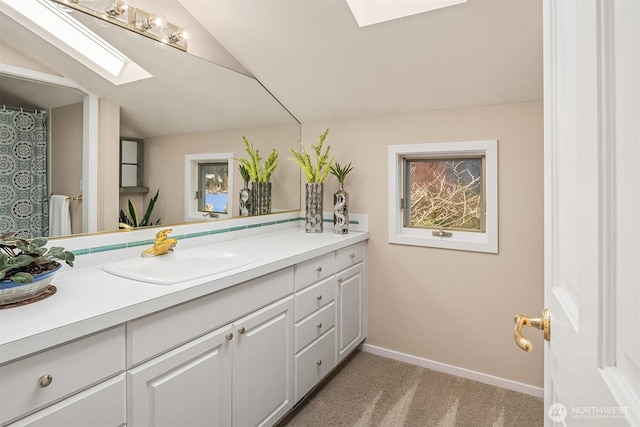 9330 SE Shoreland Dr, Bellevue, WA 98004 - full bathroom featuring vaulted ceiling with skylight, baseboards, and vanity