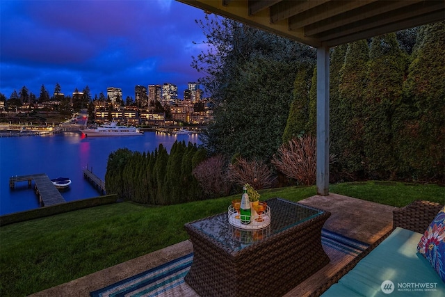 9330 SE Shoreland Dr, Bellevue, WA 98004 - patio terrace at dusk featuring a water view, a view of city, a lawn, and a boat dock