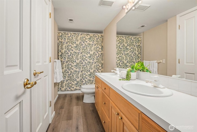 9330 SE Shoreland Dr, Bellevue, WA 98004 - full bath featuring toilet, visible vents, a sink, and wood finished floors