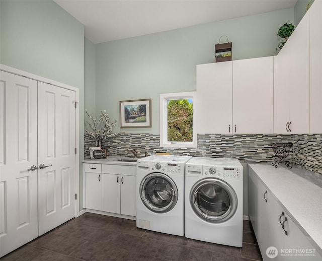 9330 SE Shoreland Dr, Bellevue, WA 98004 - laundry area featuring independent washer and dryer, cabinet space, a sink, and dark tile patterned floors
