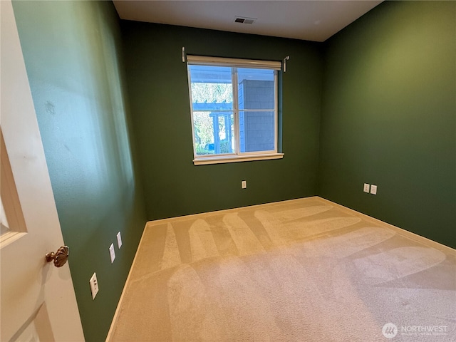 unfurnished room featuring carpet and visible vents