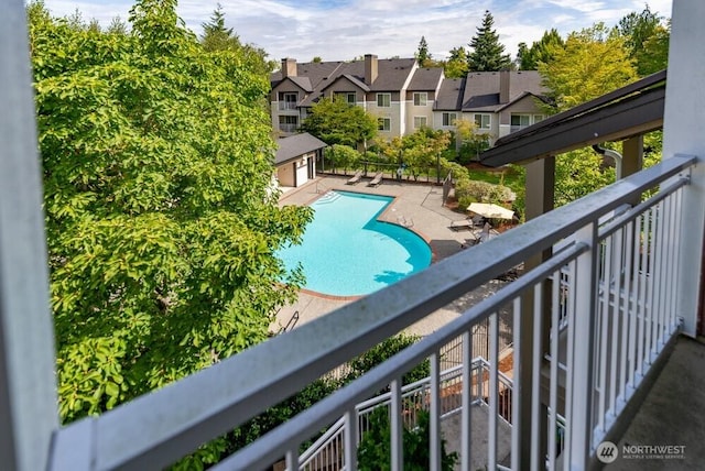 pool with an outbuilding and a residential view