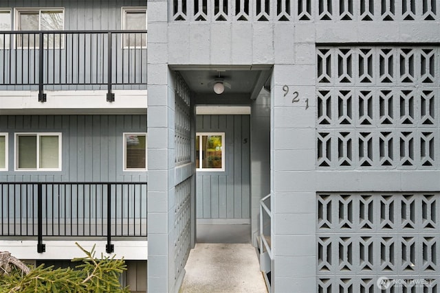 view of exterior entry featuring concrete block siding