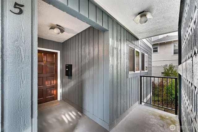 view of exterior entry featuring board and batten siding