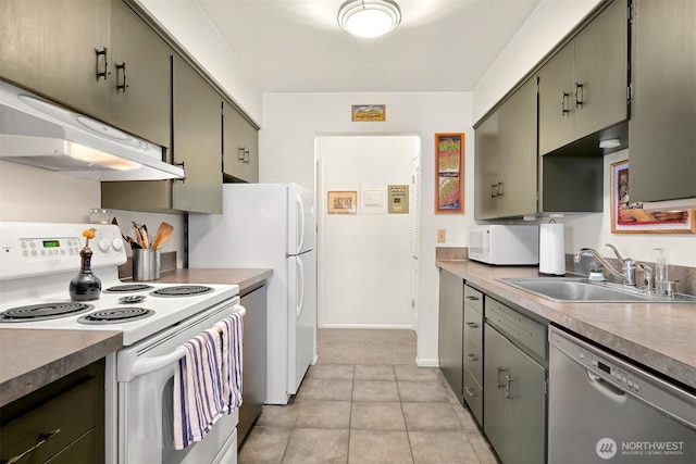 kitchen with light tile patterned floors, under cabinet range hood, white appliances, a sink, and green cabinetry