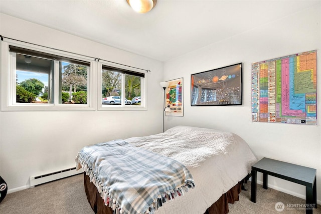 bedroom featuring baseboards, a baseboard heating unit, and carpet flooring