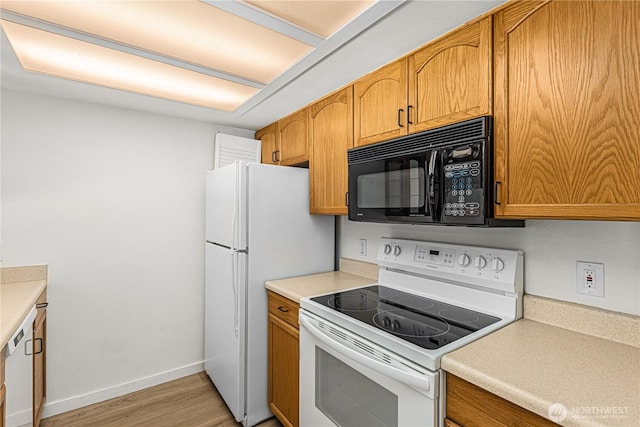 kitchen featuring white appliances, baseboards, brown cabinetry, light countertops, and light wood-style floors