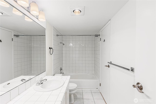 full bathroom with washtub / shower combination, tile patterned flooring, vanity, and toilet