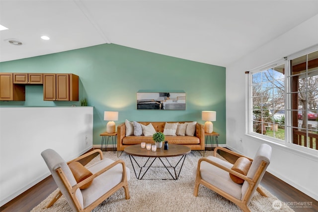 living area with lofted ceiling, recessed lighting, wood finished floors, and baseboards