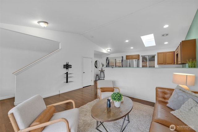 living area featuring dark wood-style floors, lofted ceiling with skylight, baseboards, and recessed lighting