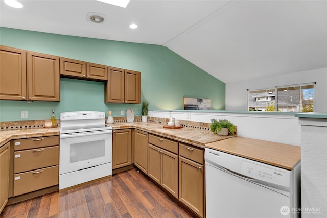 kitchen with dark wood-style flooring, recessed lighting, light countertops, vaulted ceiling, and white appliances