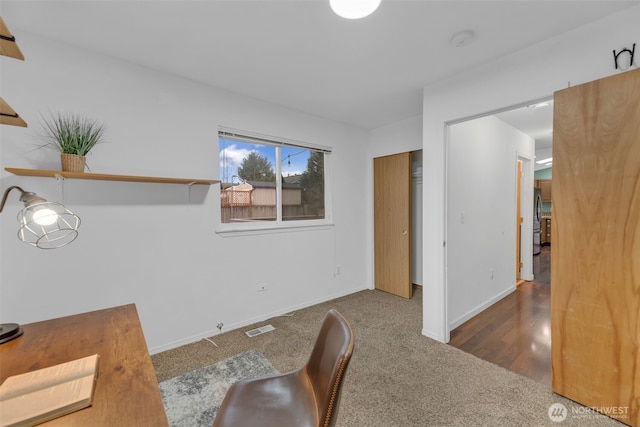 carpeted home office with visible vents and baseboards