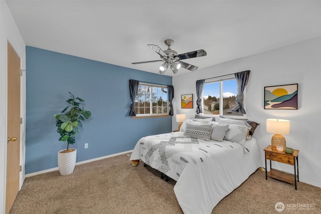 carpeted bedroom with ceiling fan and baseboards