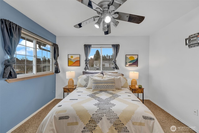 carpeted bedroom with ceiling fan and baseboards