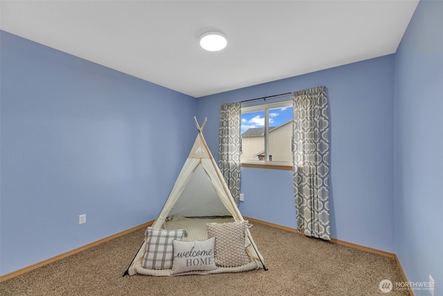 rec room with carpet flooring and baseboards