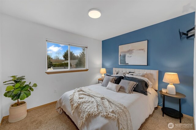 carpeted bedroom with baseboards