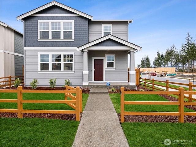 view of front of house featuring a front yard and fence