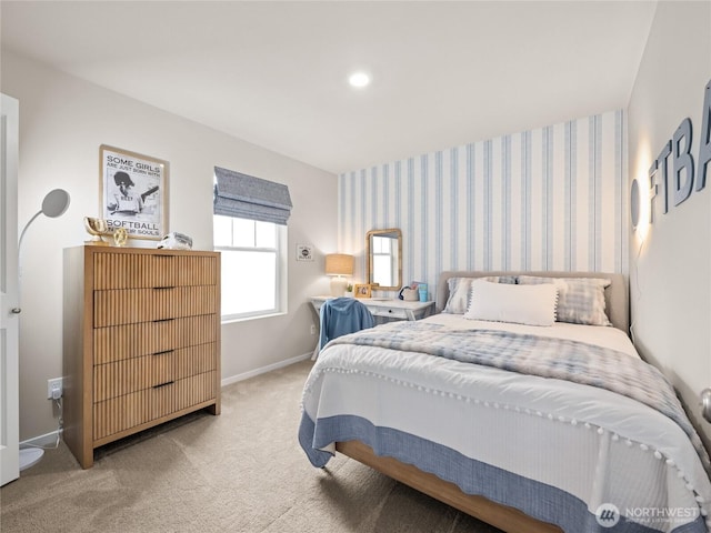 carpeted bedroom featuring baseboards, an accent wall, and wallpapered walls