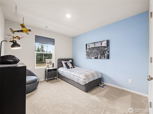 carpeted bedroom featuring visible vents and baseboards