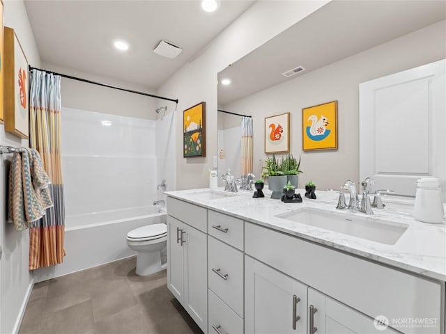 full bathroom featuring shower / tub combo with curtain, a sink, toilet, and double vanity