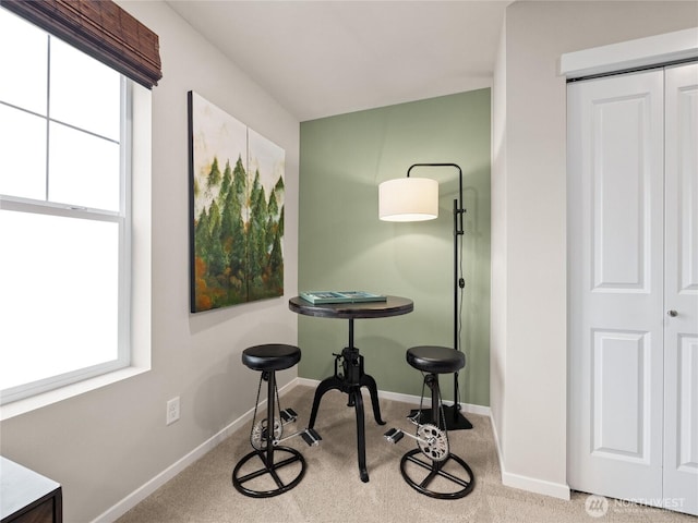 carpeted dining area with a wealth of natural light and baseboards