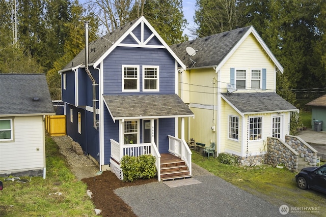 view of front facade with a porch and roof with shingles