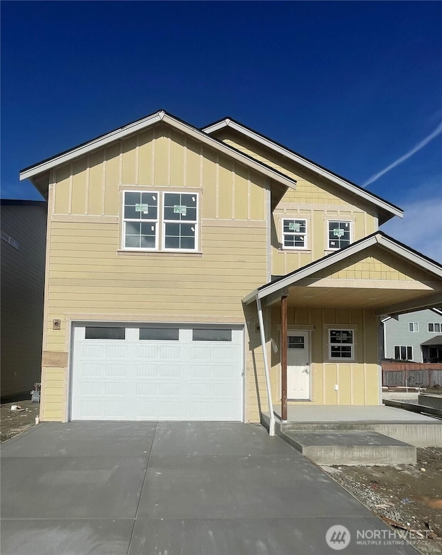 view of front of house with a garage, concrete driveway, and board and batten siding