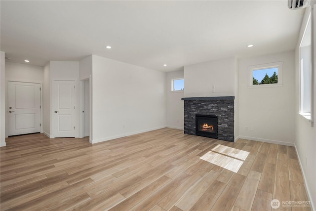 unfurnished living room with light wood finished floors, a fireplace, and recessed lighting