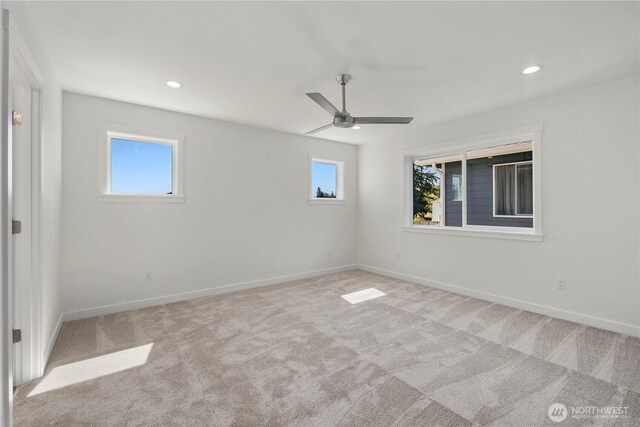 empty room featuring carpet, baseboards, and recessed lighting