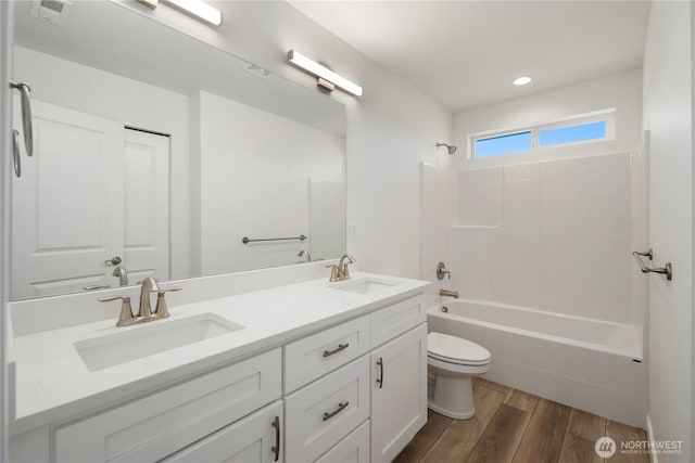 full bath featuring visible vents, wood finished floors, a sink, and toilet