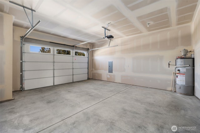 garage featuring strapped water heater, electric panel, and a garage door opener