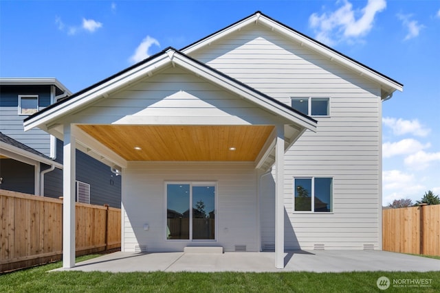 rear view of house featuring crawl space, a patio area, and fence