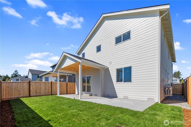 back of property with a yard, crawl space, a patio area, and a fenced backyard