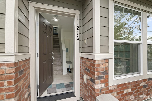 view of exterior entry with brick siding