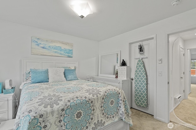 bedroom featuring light colored carpet