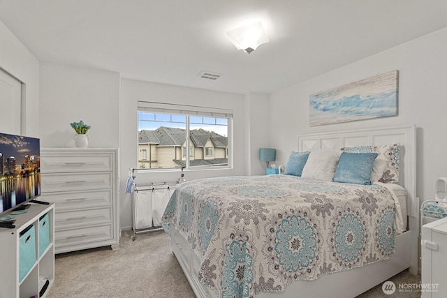 carpeted bedroom featuring visible vents