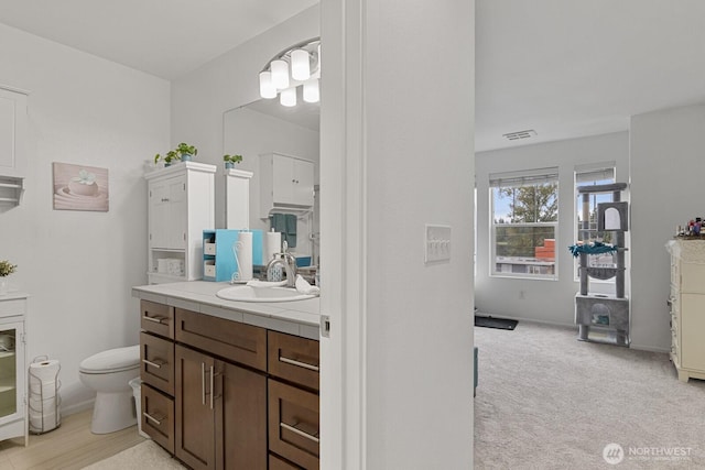 bathroom featuring toilet and vanity