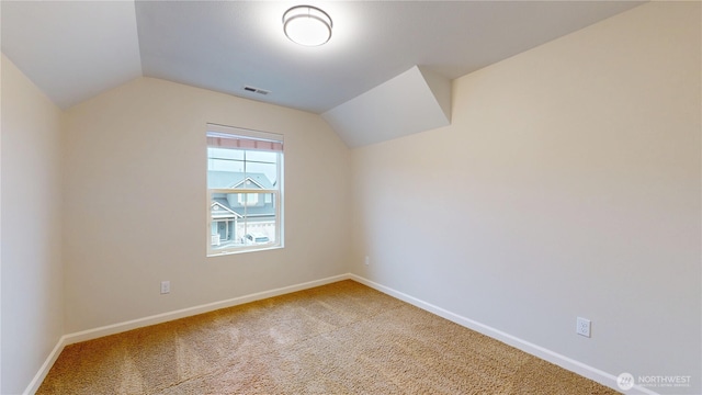 bonus room with carpet floors, baseboards, visible vents, and vaulted ceiling