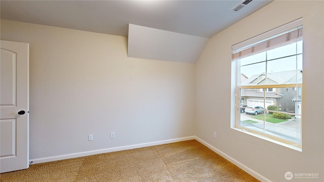 empty room featuring baseboards, plenty of natural light, visible vents, and light colored carpet