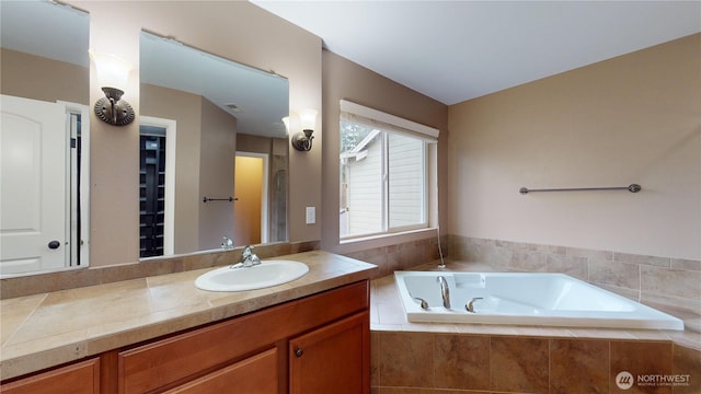 full bathroom with a garden tub, visible vents, and vanity