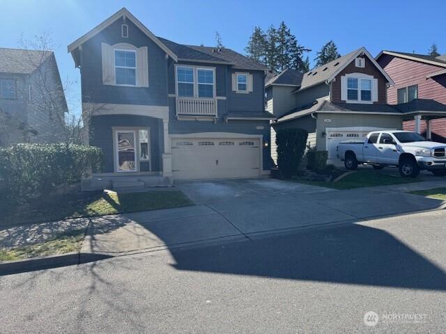 view of front of property with driveway and an attached garage