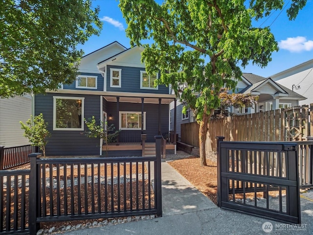 view of front of house with a porch and fence